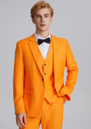 Man wearing an orange suit with a black bow tie on a gray background