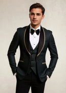 Man wearing a formal black suit with gold trim on a plain background