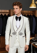 Man wearing a white suit with black bow tie in a clothing store.