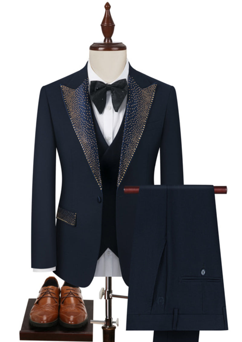 Navy blue tuxedo with decorative lapels on a mannequin, paired with brown shoes.