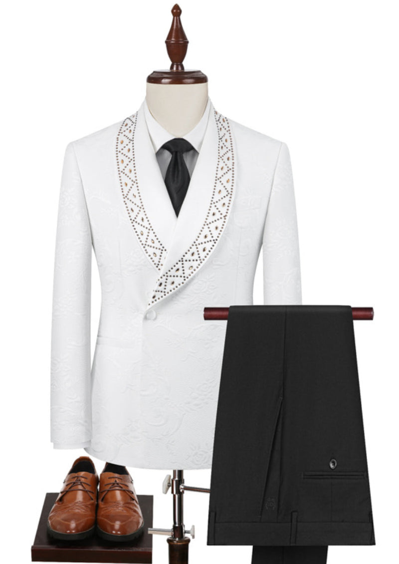 White suit jacket with black pants and brown shoes on a white background
