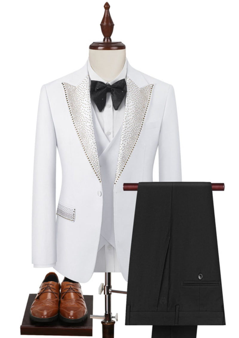 White tuxedo with black bow tie, vest, and pants on a mannequin with brown shoes.