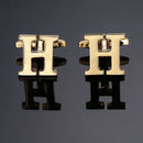 Gemelos dorados con letras de 26 dimensiones